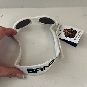 Baby Banz sunglasses new w tags, White baby Banz sunglasses & strap no glare